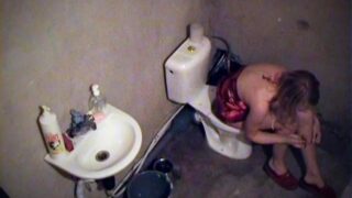 Girl smoking on toilet in voyeur movie